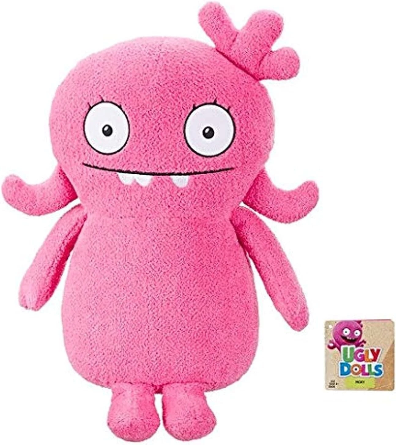 Peluche Ugly Dolls Moxy original de Hasbro en color rosa, tamaño grande de 40 cm aprox., con expresión simpática y textura suave. Ideal como muñeco para abrazar y decorar habitación infantil.