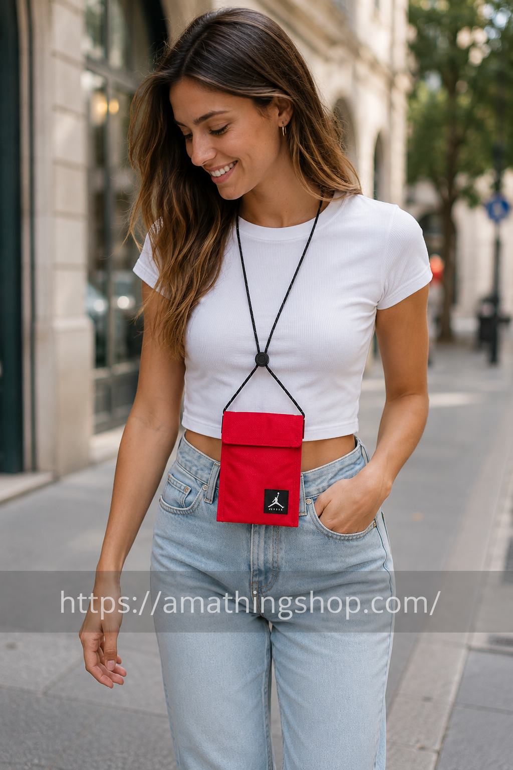 Mujer joven llevando mini bandolera Jordan Air Tri Fold roja durante paseo urbano por ciudad