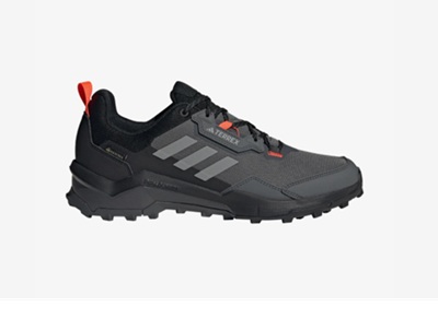 Zapatillas Adidas Terrex AX4 para hombre en color Grey Six con detalles Solar Red. Modelo HP7391 diseñado para senderismo y rutas de montaña con suela Continental. Vista lateral mostrando su diseño robusto y agarre todoterreno.